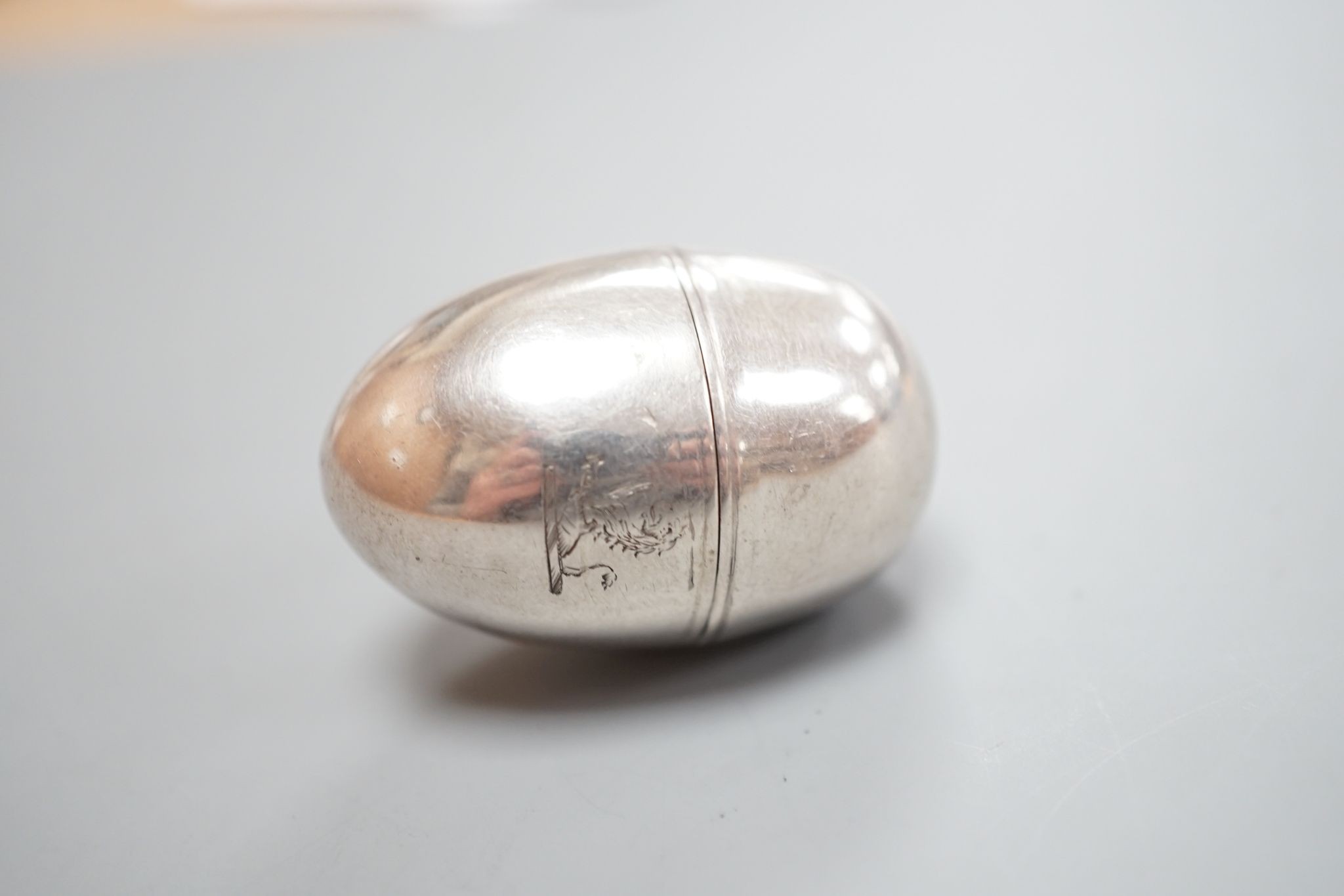 A George III silver egg shaped vinaigrette, by SM or WS, London, 1796, with engraved crest, 40mm.